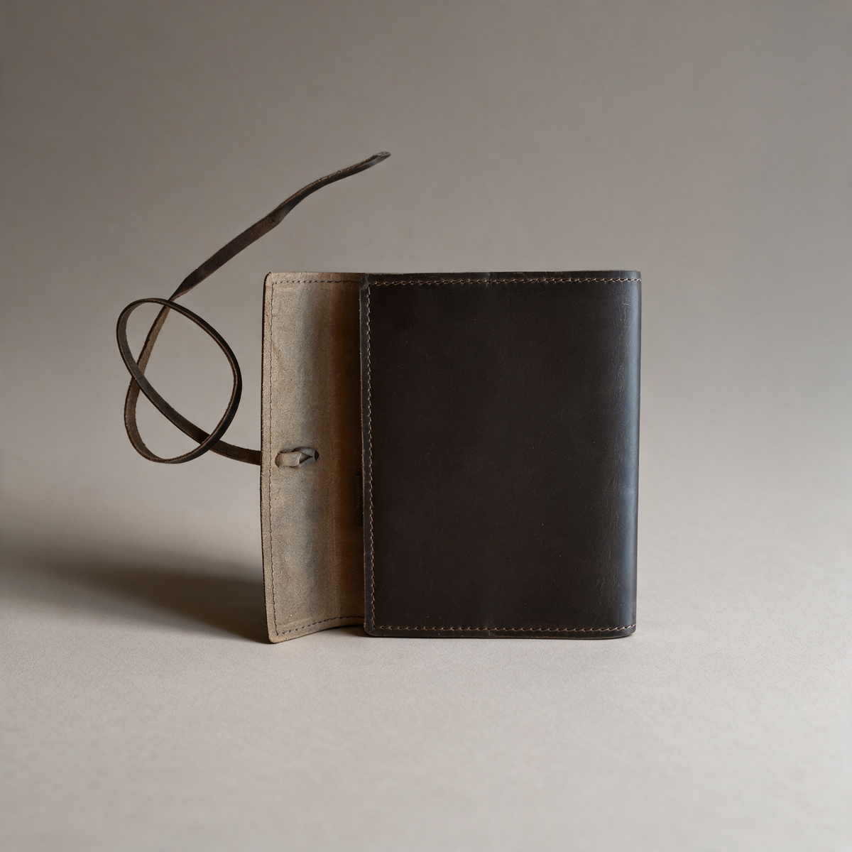 Leather journal on a warm grey studio background