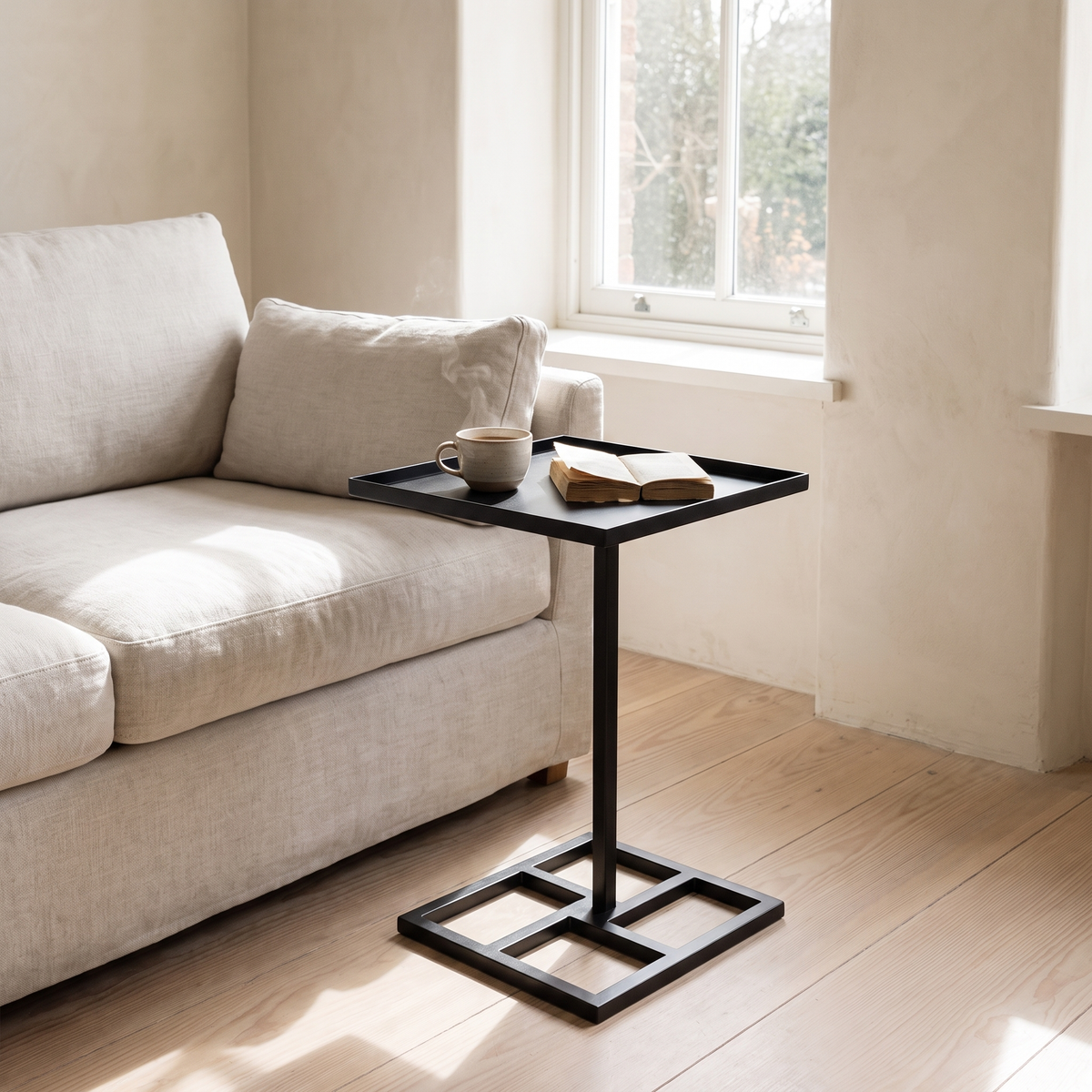 Steel Side Table beside a linen sofa in morning light