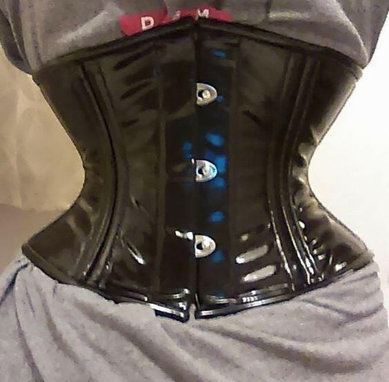 Close view of the black PVC waspie showing the double row of boning and busk
