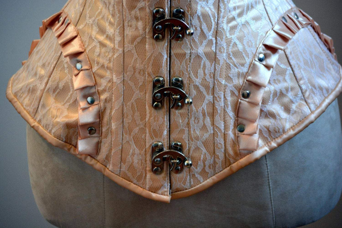 Detail of the steampunk vest showing the lace overlay and clasp hardware
