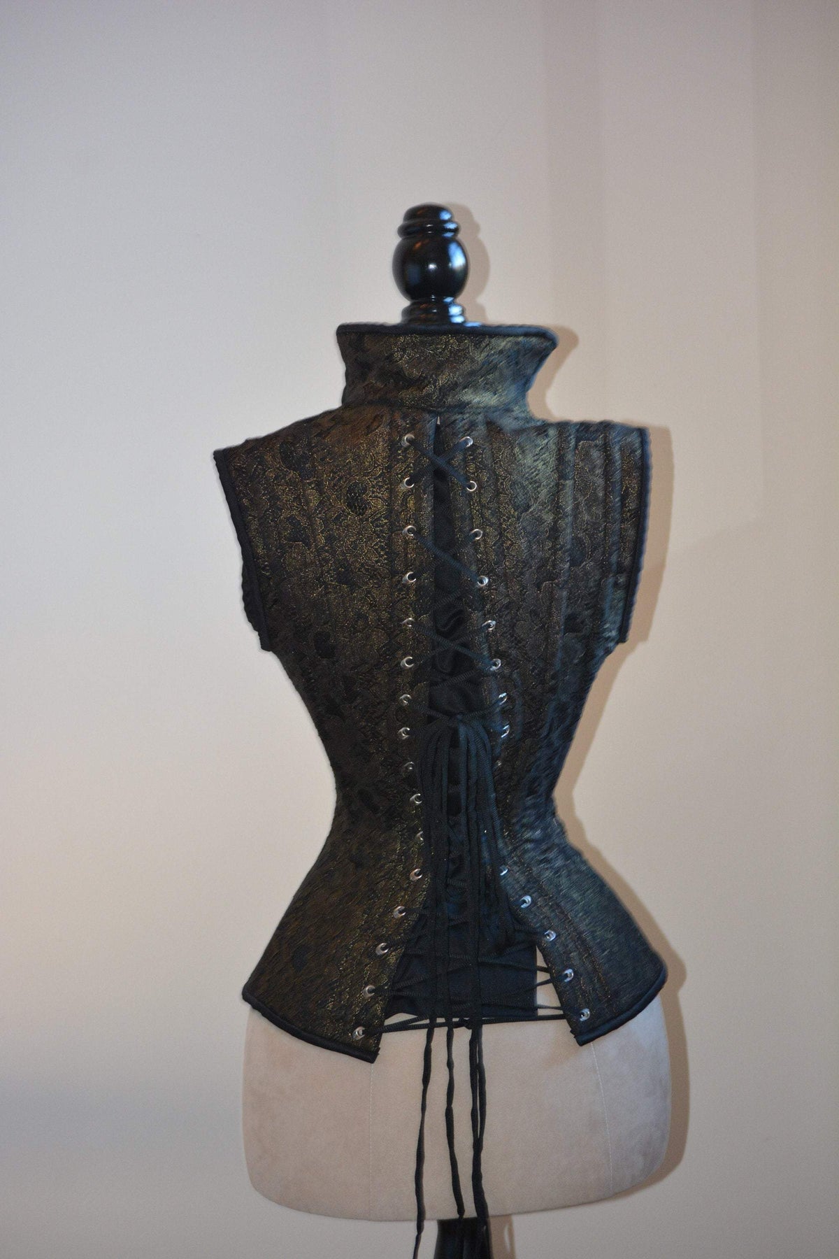 The gothic black corset vest of the set, showing the collar and back lacing