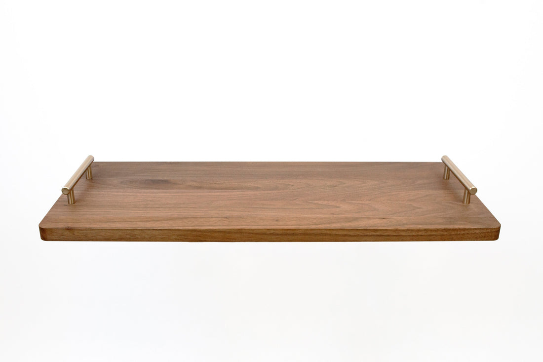 Solid walnut serving board, unstained and oiled, with brass handles