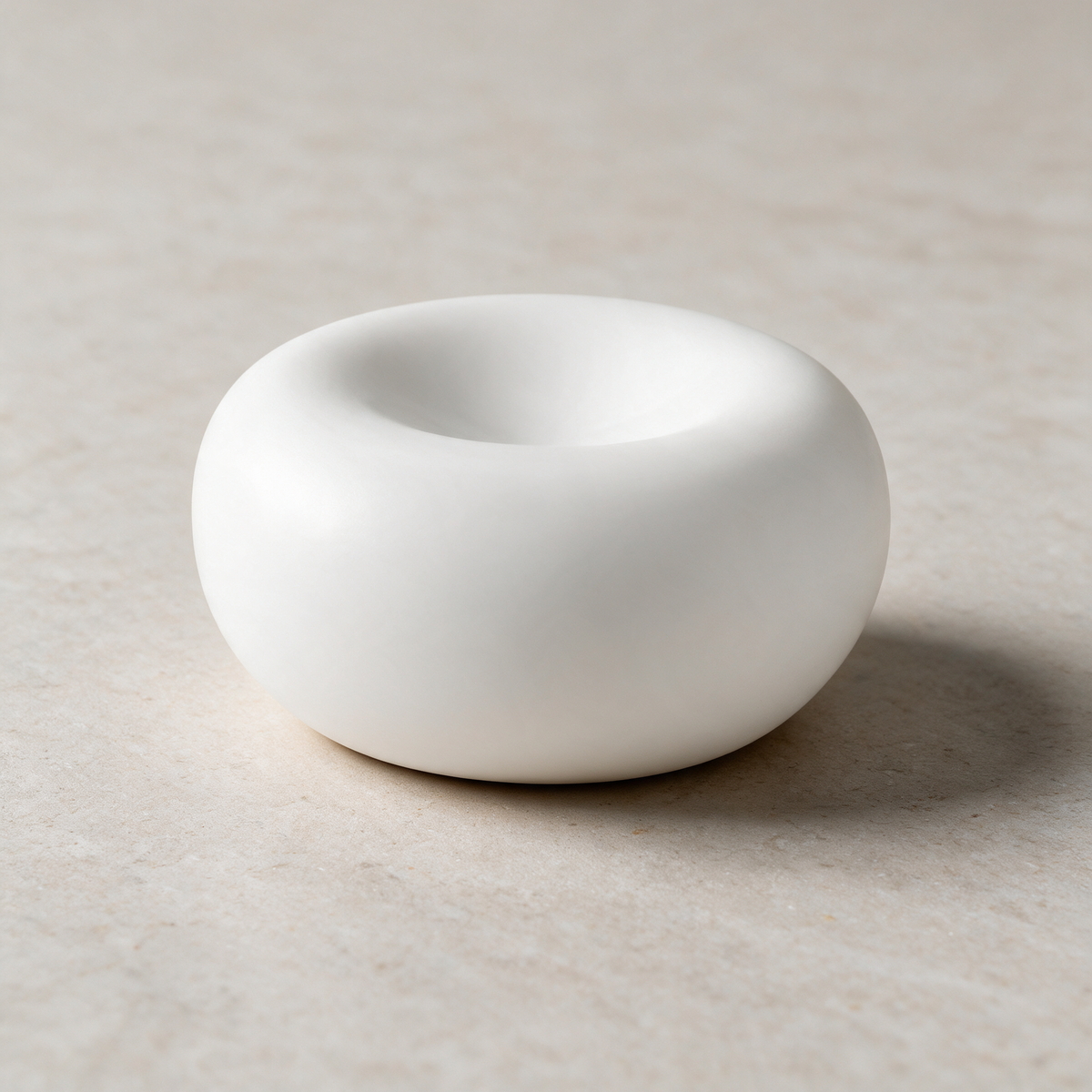 Fluted porcelain plate on a warm grey studio background