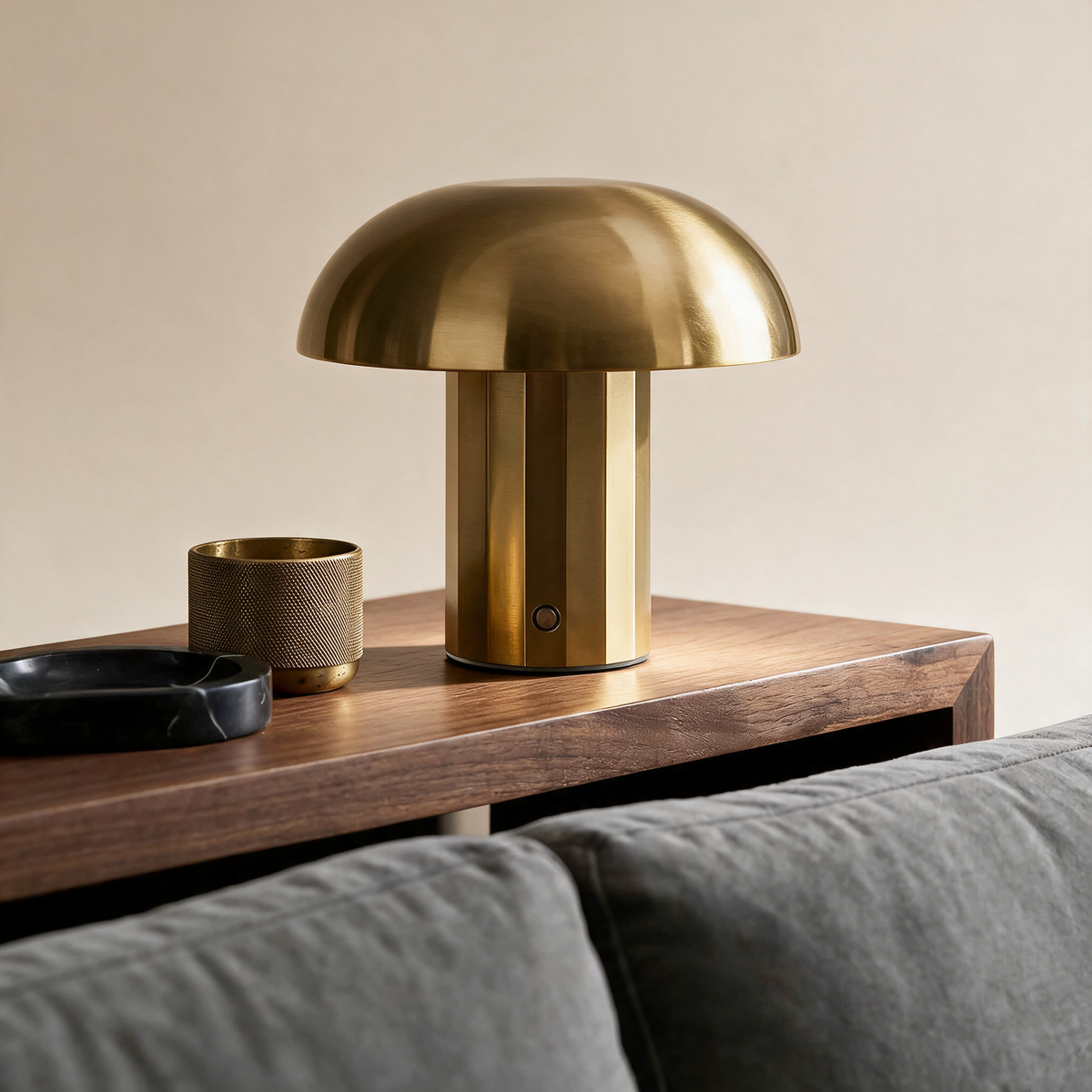 Brass table lamp on a warm grey studio background