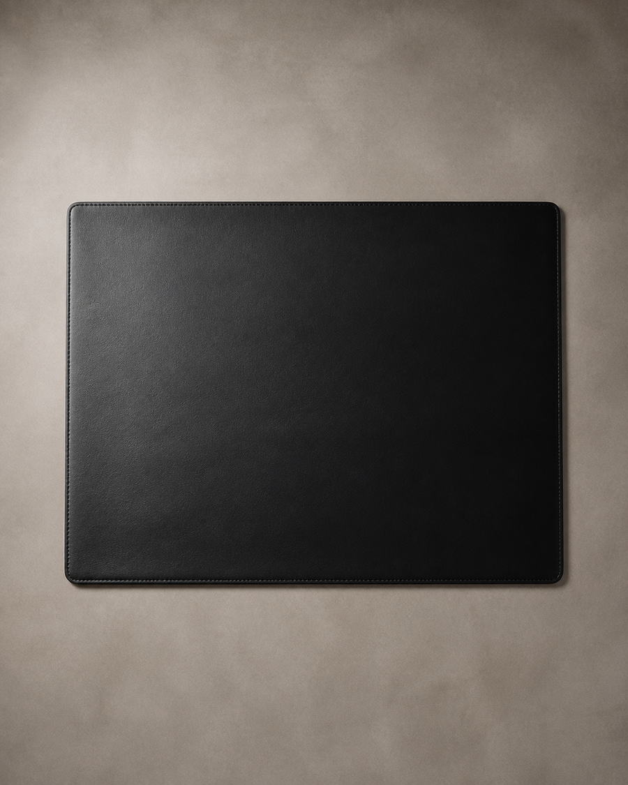 ALCOVE No. 16 black leather desk pad on warm grey background